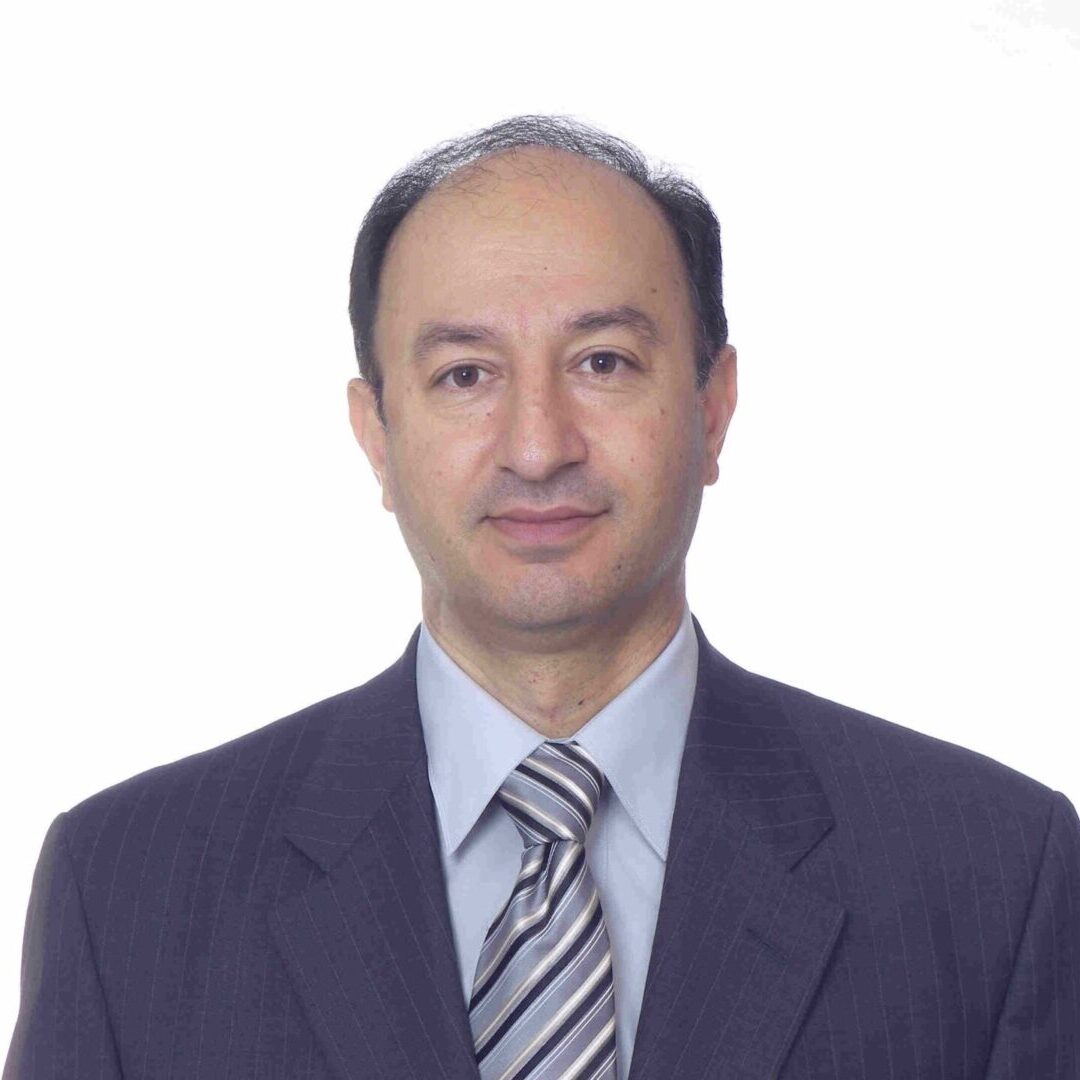 Man in suit with neutral expression.